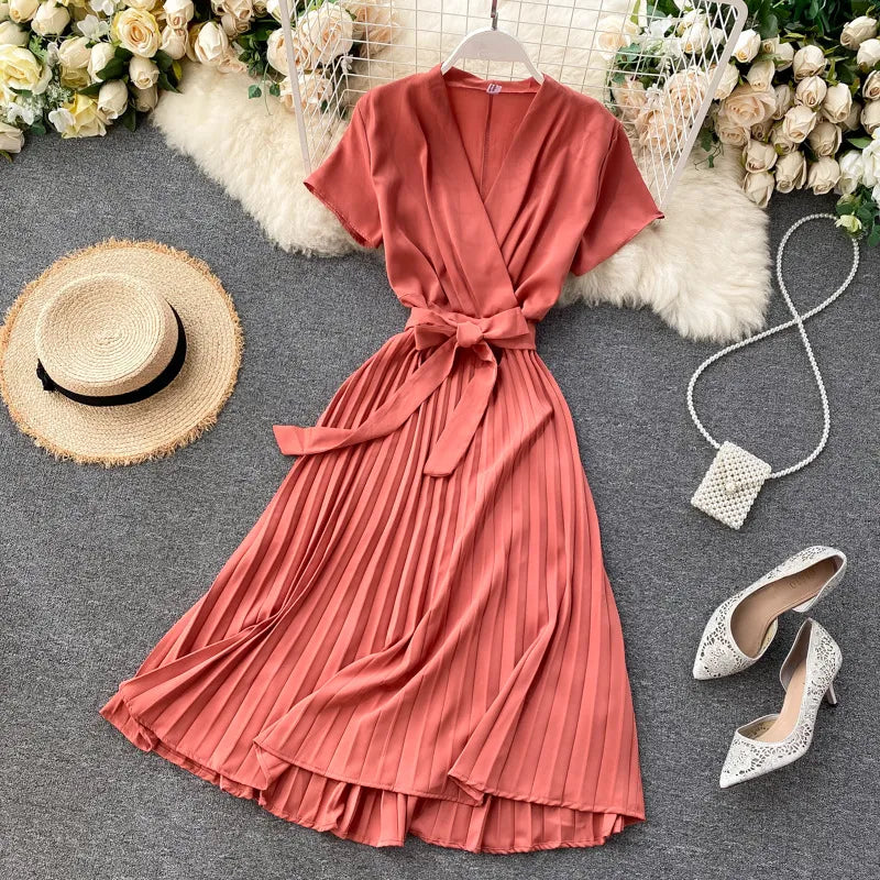 High-waisted pleated midi dress with V-neckline in solid color
